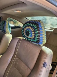 a crocheted seat cover in the back of a car